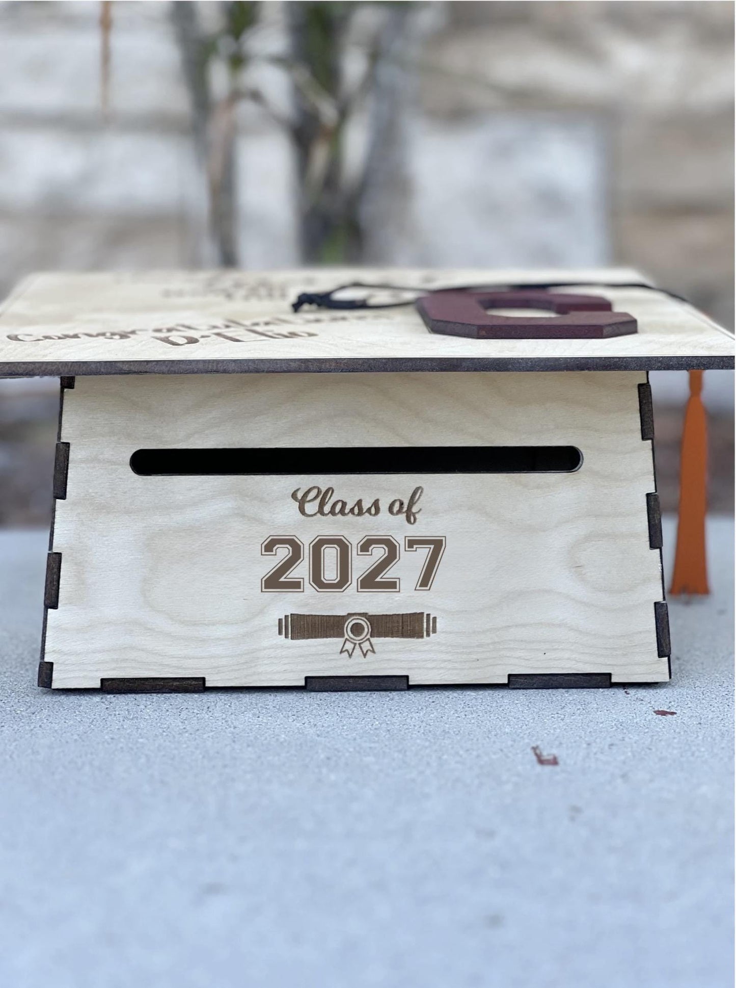 Wooden graduation cap card box shown from the side