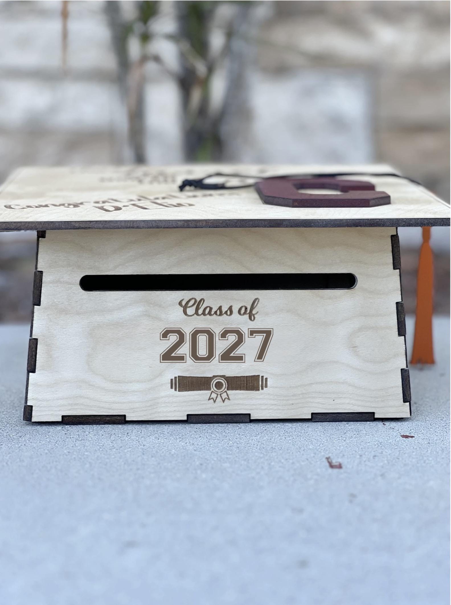Wooden graduation cap card box shown from the side